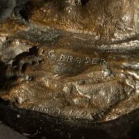 Alt text: Bronze sculpture, signature detail