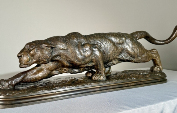 Alt text: Bronze sculpture of a prowling mountain lion
