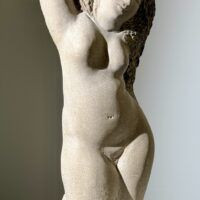 Alt text: Carved stone sculpture of a standing nude woman