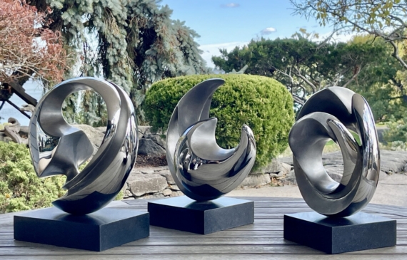 Alt text: Trio of rounded stainless steel sculptures