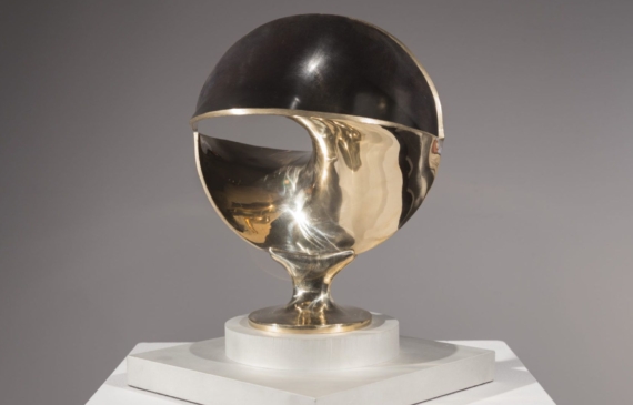 Alt text: Abstract bronze sculpture of circles polished and warped