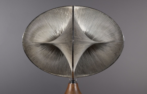 Alt text: Abstract sculpture with warped geometric shapes that create an optical illusion