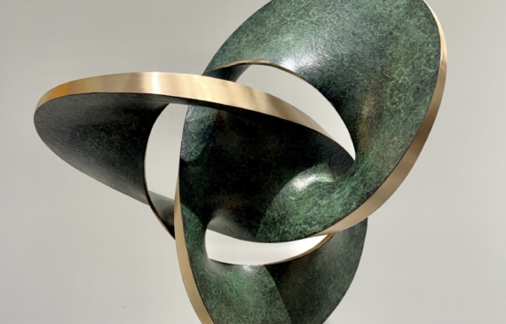 Alt text: Abstract bronze sculpture in green and gold