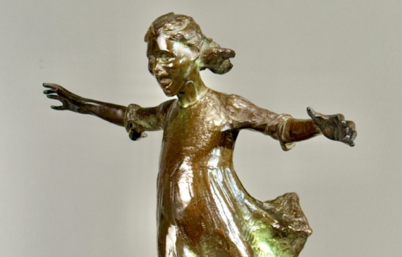 Alt text: Bronze sculpture of a girl roller skating on one foot