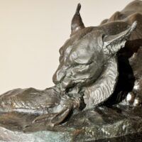 Alt text: Bronzes sculpture of a lynx eating a hare, detail