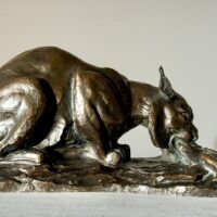 Alt text: Bronzes sculpture of a lynx eating a hare
