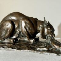 Alt text: Bronzes sculpture of a lynx eating a hare
