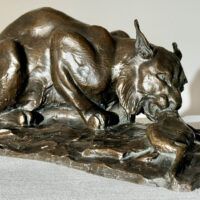 Alt text: Bronzes sculpture of a lynx eating a hare