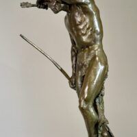Alt text: Bronze sculpture of a Native American man looking into the distance