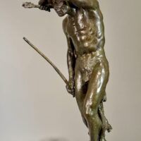 Alt text: Bronze sculpture of a Native American man looking into the distance