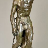 Alt text: Bronze sculpture of a Native American man looking into the distance