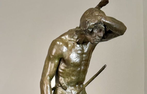 Alt text: Bronze sculpture of a Native American man looking into the distance