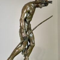 Alt text: Bronze sculpture of a Native American man looking into the distance