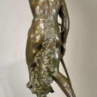 Alt text: Bronze sculpture of a Native American man looking into the distance