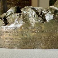 Alt text: Bronze sculpture, inscription detail