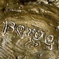 Alt text: Bronze sculpture, signature detail