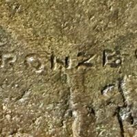 Alt text: Bronze sculpture, foundry mark detail