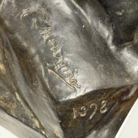 Alt text: Bronze sculpture, signature and date detail