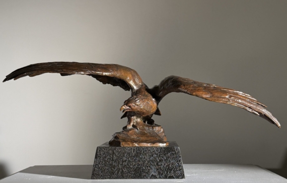 Alt text: Bronze sculpture of an eagle with wings spread